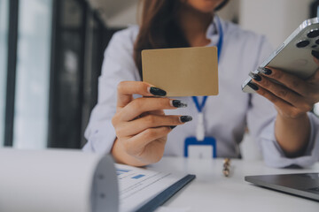 .Women holding credit card and using smartphones at home.Online shopping, internet banking, store...