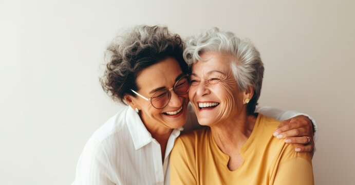 An Older Woman Hugging A Younger Woman