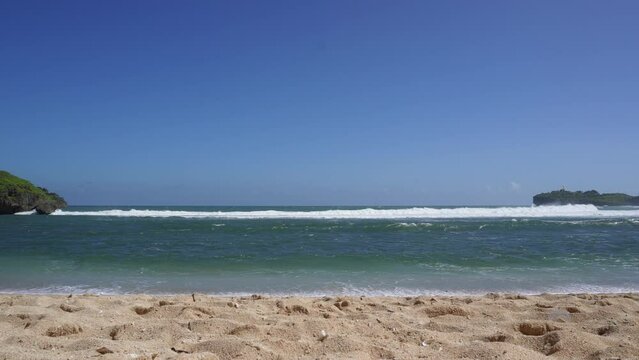 Sea waves splash on beach shore. Breaking waves at the beach. Ocean Wave splashing on coastline.