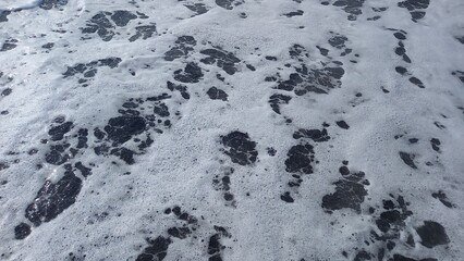 Beach water with white foams