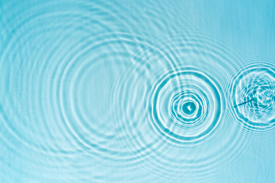 Beautiful pattern of circles of drops on a background of water Cosmetic moisturizing essence Abstract natural backdrop