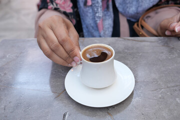  women drinking turkish coffee at cafe 