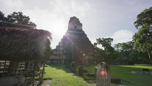 Silhouette of ancient Tikal national park pyramid - steady cam forward