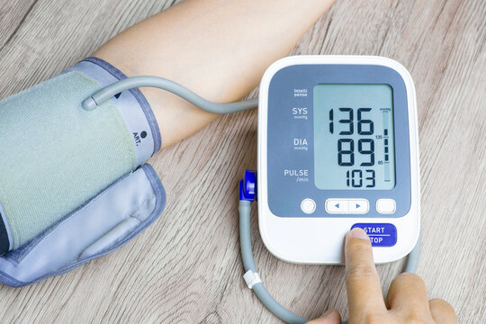 Man check blood pressure monitor and heart rate monitor with digital pressure gauge. Health care and Medical concept	
