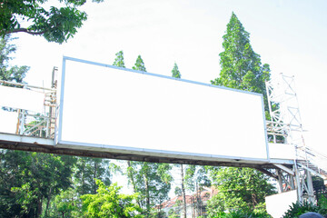 Billboard mockup on the wall of a pedestrian bridge with an empty outdoor advertising screen