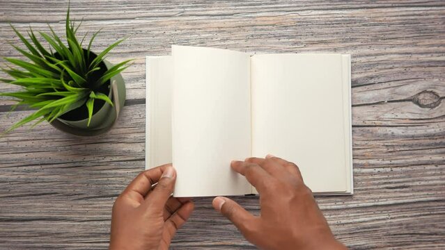top view of hand turning a pager of a diary 