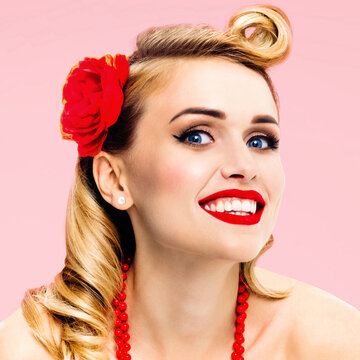 Portrait image of happy excited smiling beautiful woman. Pin up blond girl at studio. Retro and vintage concept. Rose pink color background. Square photo.