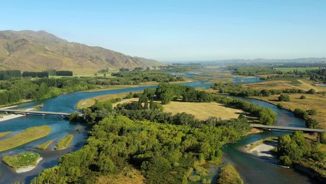 Wide scenic valley of Waitaki river near Kurow town in mountains of New Zealand.

