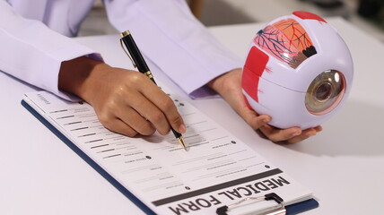 Initial AI illustration of a close-up of a female doctor's hand signing a medical document on a...
