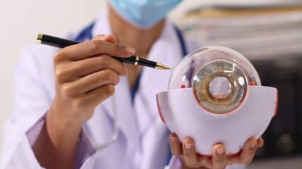 Initial AI illustration of a close-up of a female doctor's hand signing a medical document on a...