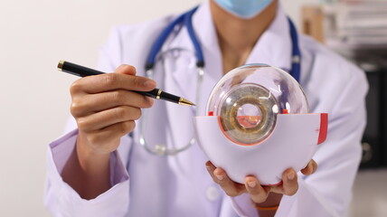 Initial AI illustration of a close-up of a female doctor's hand signing a medical document on a clipboard. and recommending certain medicines to patients on a laptop