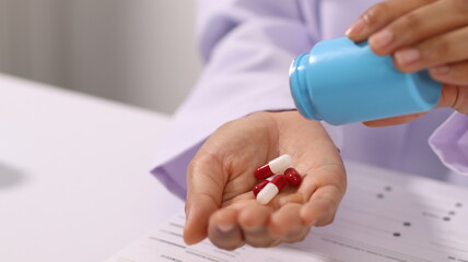 Initial AI illustration of a close-up of a female doctor's hand signing a medical document on a...