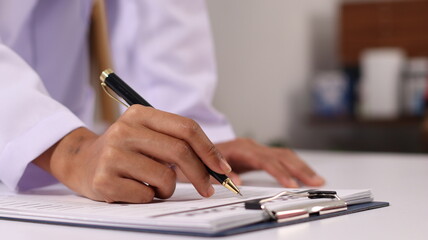 Initial AI illustration of a close-up of a female doctor's hand signing a medical document on a...
