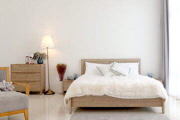 Modern interior of light bedroom with withe bed, cozy comfortably bedroom interior.
