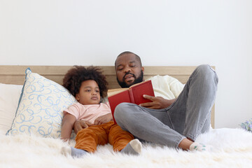 Happy African family, father and son spending time together, young boy with black curly hair and...