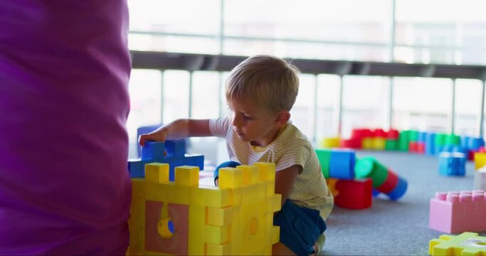 A child plays with toy building blocks in a children's recreational center