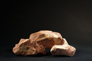 Pieces of granite stone on black background studio shot