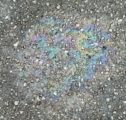 A trace of gasoline on the asphalt as a background. Texture