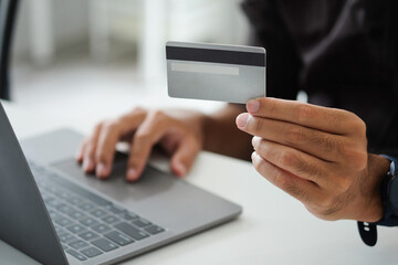 man using credit card Do transactions/banking online.
