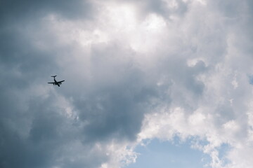 White passenger airplane flying in the sky clouds in the background