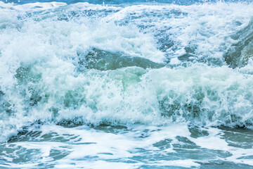 Wave splashing close-up. Crystal clear sea water, in the ocean in San Francisco Bay, blue water, pastel colors.