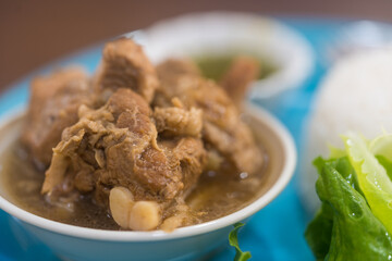 Stewed pork ribs in a bowl. Close up