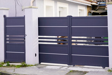 door modern steel aluminum grey gate portal and pedestrian door of suburb house facade