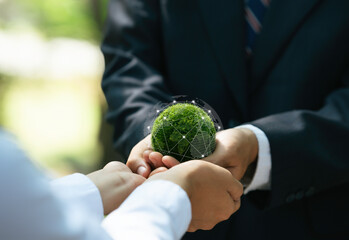 Protecting Planet Environment and Earth Day. Business hands holding green Earth for Responsibility...