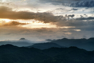 Naklejka na ściany i meble Landscape of mountains at sunset