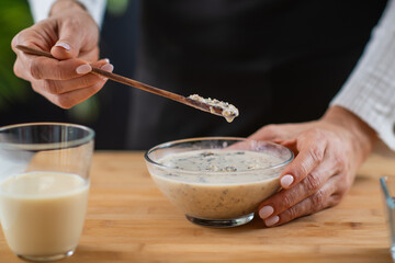 Oatmeal preparation featuring oats, soy milk, and plant protein powder, showcasing the fusion of...