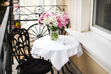 served table with a bouquet of flowers on the balcony in the hotel