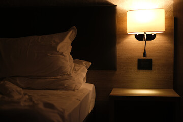 night light above the bed in a modern hotel room interior