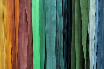 Plastic zippers of different colors. Assorted YKK nylon zippers. The hottest colors of the season.