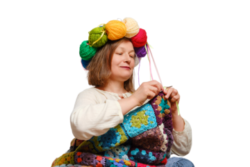 An adult woman knits a plaid crochet with balls of yarn on her head, isolated on white background