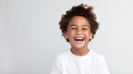 A professional portrait studio photo of a cute mixed race boy child model with perfect clean teeth...