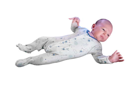 Portrait of a baby boy aged 1 month lying with his eyes open in a crib, isolated on a white background. Caucasian child in the children bedroom on the bed