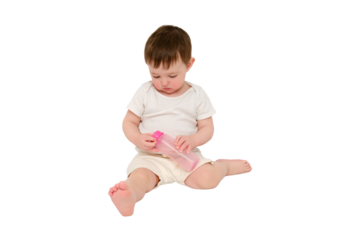 Baby breaks a milk bottle while pressing the nipple, studio, isolated on white background. Kid about two years old (one year nine months)