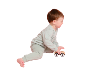 Happy toddler baby is playing with a toy car against a pink background, isolated on white background. Child boy rolls a wooden toy car Kid age one year eight months, full height