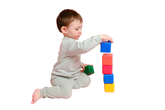 Happy toddler baby plays with cubes on studio, isolated on white background. Child boy builds a tower of toys, isolated on white background. Kid age one year eight months, full height