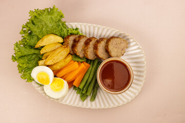Beef Galantine or Galantine Sapi, De Boned Stuffed Meat Served with Steamed Mix Veggies , Potatoes Wedges, and Gravy Sauce.