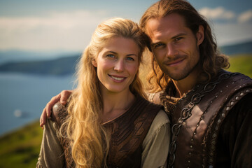 Viking couple, the man in his mid-30s and the woman in her early 30s, both with blonde hair and blue eyes, standing side by side, exuding strength and unity. They’re on a grassy hill