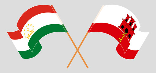 Crossed and waving flags of Tajikistan and Gibraltar