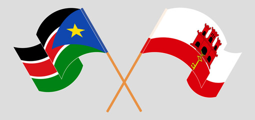 Crossed and waving flags of South Sudan and Gibraltar