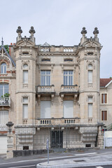 Fototapeta na wymiar Nancy, France - May 13th 2020 : Focus on a building built at the beginning of the 19th century with numerous sculptures and decorations on its facade.