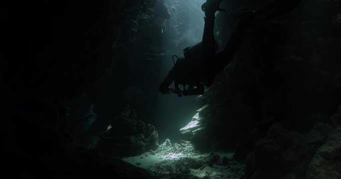 a diver is using a small camera to film the subaquatic environment