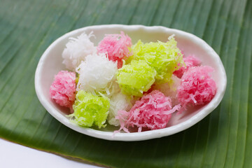 Sweet coconut balls, crispy coconut candies (Maprao Gaew). Thai traditional dessert