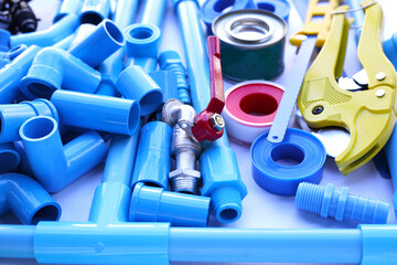 Plumber equipment with blue pvc pipe connections for plumbing work.