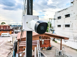 Installing CCTV cameras outside buildings and houses by attaching them to the wall.