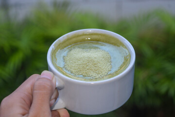 Close up of a glass of milky matcha drink