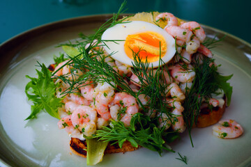Traditional Scandinavian shrimp toast (toast Skagen) with dill, egg and mayonnaise